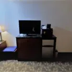 a room with TV on the table and a lamp