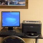 view of a desktop computer and a printer
