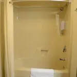 view of a bathtub with a towel in a bathroom