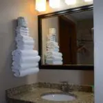 towels placed near the bathroom sink mirror